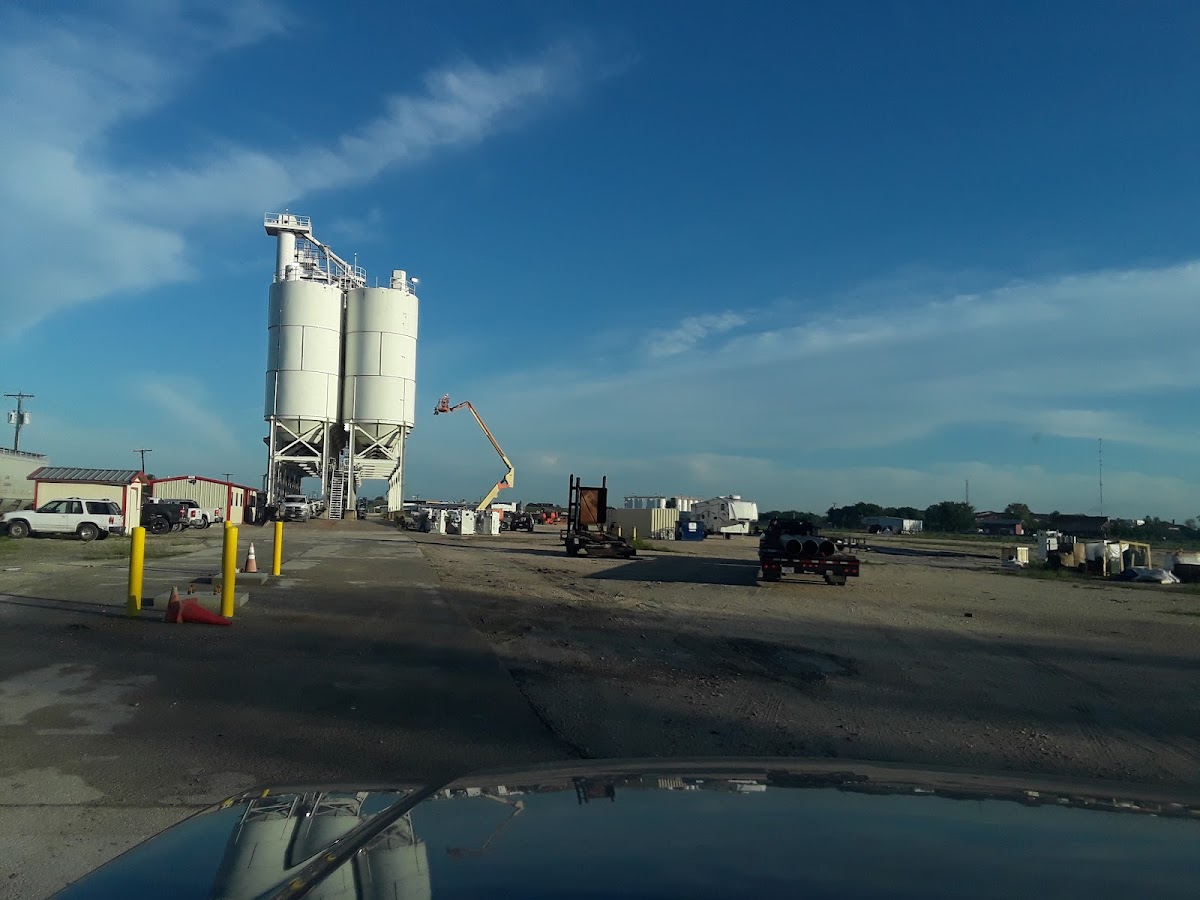 Aerial view of large industrial facility job site with cherry picker equipment