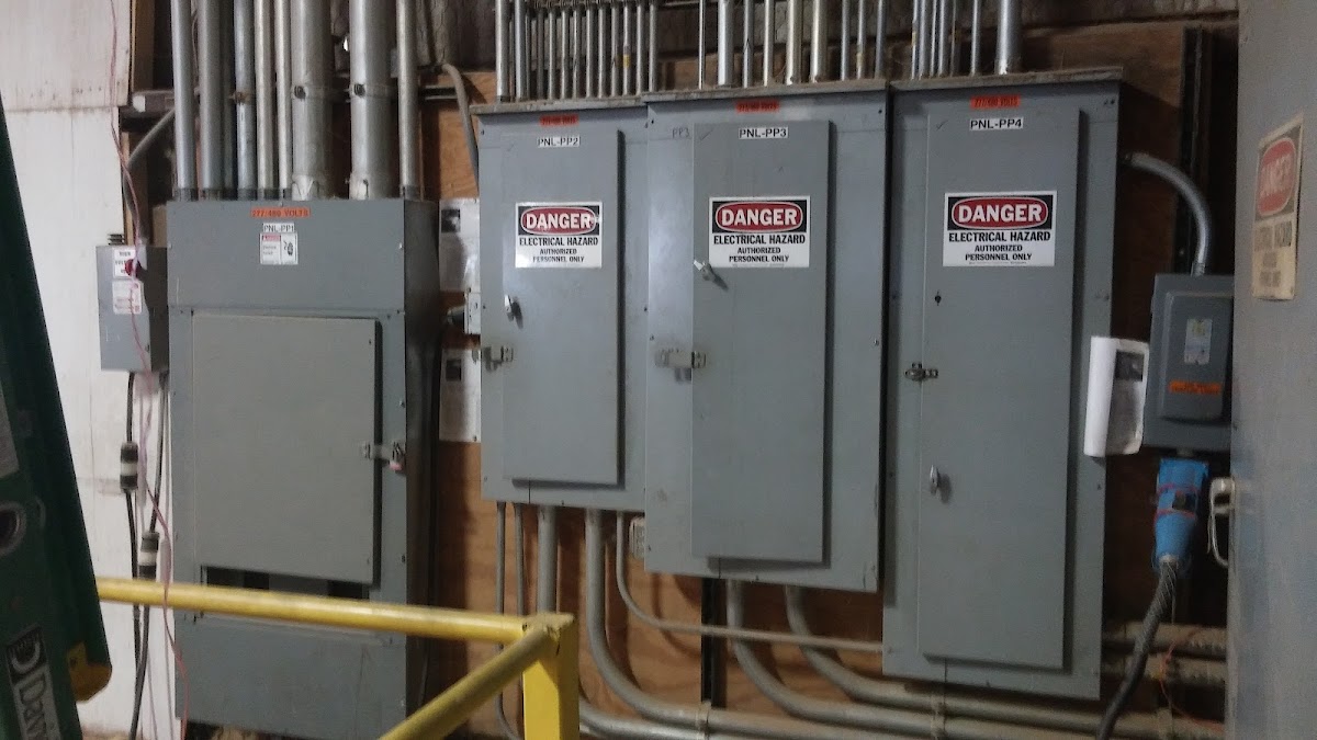 Industrial electrical panel installation by K.L.D. Electric showing labeled breaker boards